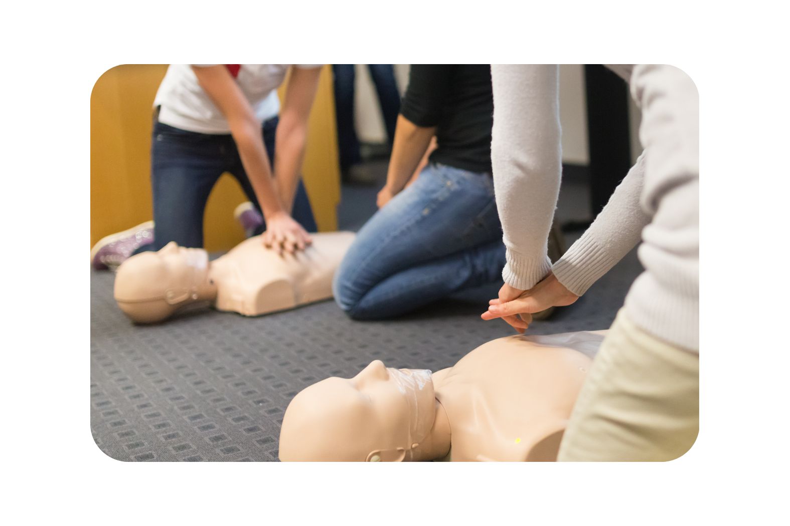 First Aid training session in Kent and Medway using CPR dummy and defibrillator